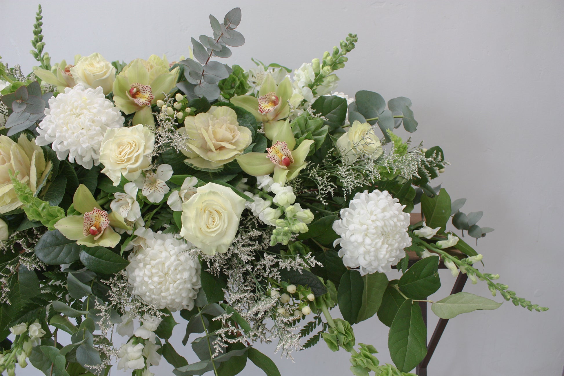 casket spray oleander floral design toronto same day flower delivery sympathy funeral etobicoke white and green flowers orchid rose eucalyptus