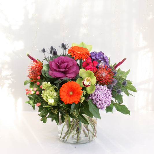 selection of bright and bold flowers in low and full vase arrangement hydrangea roses eucalyptus. Designed at oleander floral design in toronto offering same day delivery