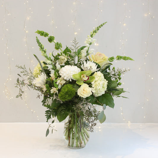 white and green tall vase arrangement hydrangea roses eucalyptus. Designed at oleander floral design in toronto offering same day delivery