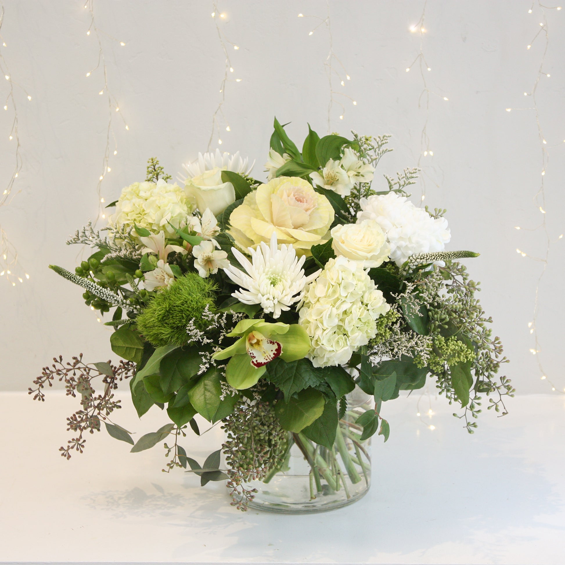 white and green low and full vase arrangement hydrangea roses eucalyptus. Designed at oleander floral design in toronto offering same day delivery
