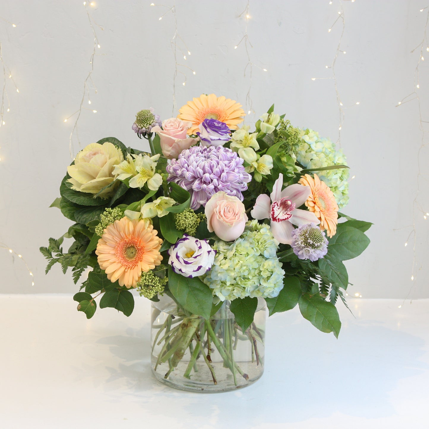 pastel coloured floral arrangement with mix of gerbera daisieds hydrangea roses eucalyptus. Designed at oleander floral design in toronto offering same day delivery