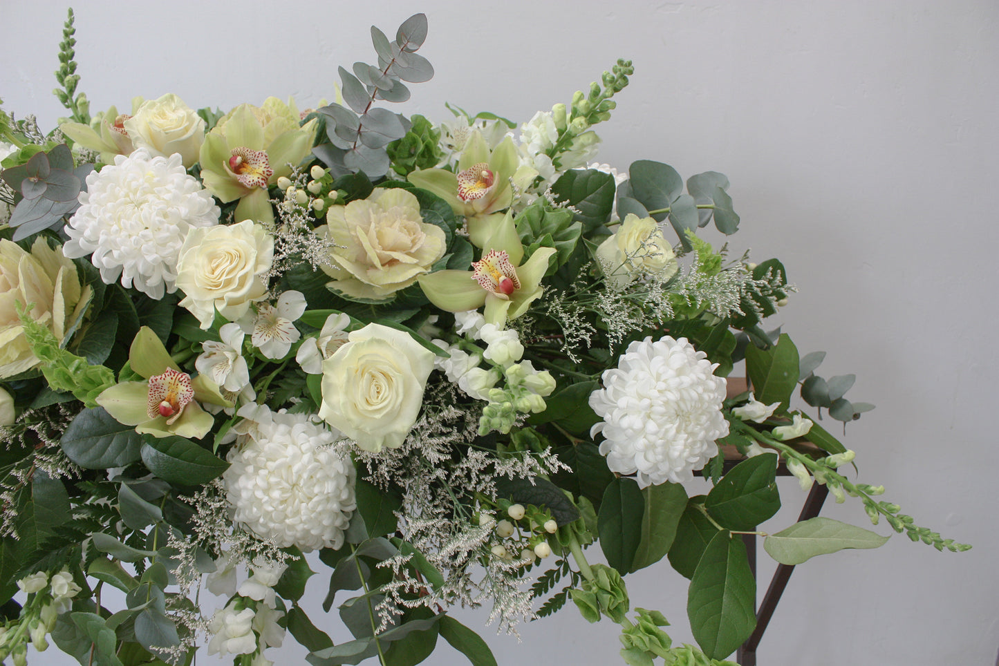 casket spray oleander floral design toronto same day flower delivery sympathy funeral etobicoke white and green flowers orchid rose eucalyptus